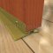 Bronze interlocking threshold applied on wooden interior door