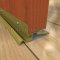 Zero 76 Bronze Interlocking Threshold on a Wooden Door