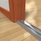 Pemko 252x3SSFG Utility Threshold with Stainless Steel on Wooden Floor