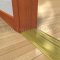 Pemko 253x4FG Bronze Mill Finish with Thermal Break on Wooden Floor