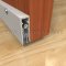 Clear Anodized Automatic Door Bottom Surface Applied to and Interior Wooden Door with Nylon Brush Seal in Raised Position