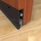 Dark Bronze Pemko Automatic Door Bottom 4131NB with Nylon Brush Seal Surface Mounted to Wooden Interior Door with Seal Closed