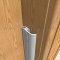 Aluminum Mill Finish Pemko Door Gasket #297 on a Wooden Door