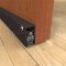 pemko 4301 dark bronze automatic door bottom surface mounted to the face of a wooden interior door with seal closed