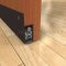 Dark Bronze Anodized Pemko Automatic Door Bottom #430 Surface Mounted to Wooden Interior Door with PemkoPrene Seal Raised