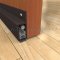 Dark Bronze Anodized Pemko Automatic Door Bottom #430 Surface Mounted to Wooden Interior Door with PemkoPrene Seal Lowered