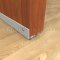 Pemko Aluminum Mill Finish Door Sweep #317N with Neoprene Bulb Seal Applied on Interior Wooden Door, Placed Beneath the Door