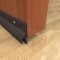 Dark Bronze Anodized Door Bottom Sweep with Rain Drip Cap on Indoor Wooden Door
