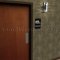 Rockwood Molded Plastic ADA Tactile Sign with Braille, Unisex and Handicap Accessible Restroom in black finish applied to interior door