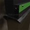 Close Up of Automatic Door Bottom with Photoluminescent Strip Applied to Metal Door in Dark