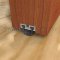Mortised Aluminum Track with Reversible Neoprene Seal applied on interior wooden door bottom