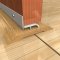 Aluminum Threshold Cap Applied on Interior Wooden Threshold for Enhanced Sealing Properties