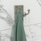 Coat hook on a wall with a towel on it