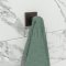 Black Wall Hook with a towel hanging on it