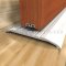 Barzen #SRM10 Mortised Door Sweep applied to wooden door with aluminum threshold